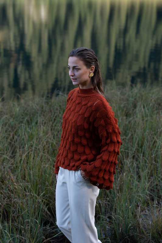 Red knitted sweater with wide sleeves