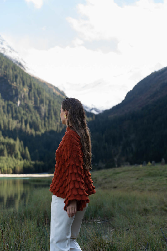 Red knitted sweater with wide sleeves